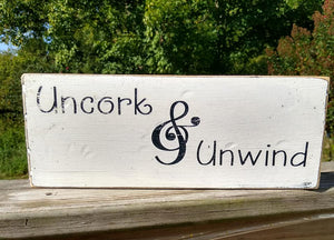 Vintage farmhouse style wooden sign "Uncork & Unwind"